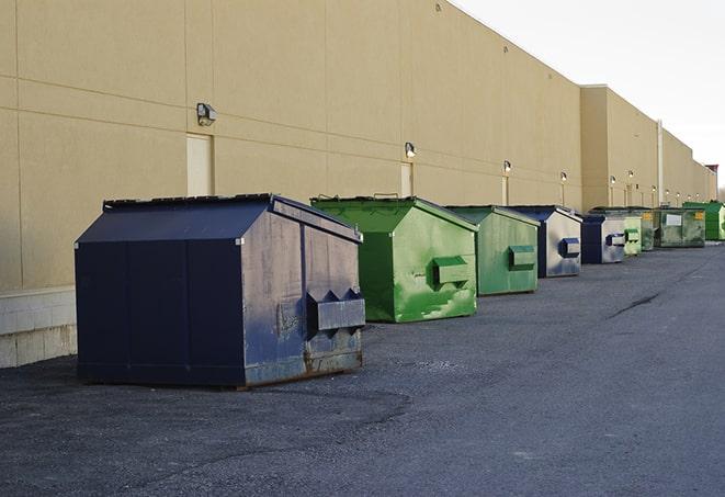 a row of construction dumpsters parked on a jobsite in Aldine, TX